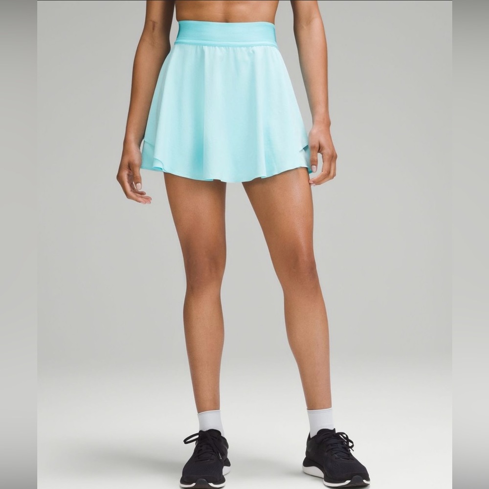 High rise, Size 0, 4". Dual-entry pocket in the liner holds a tennis balls